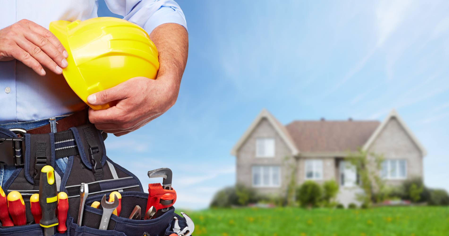 Builder handyman with construction tools. House renovation background.