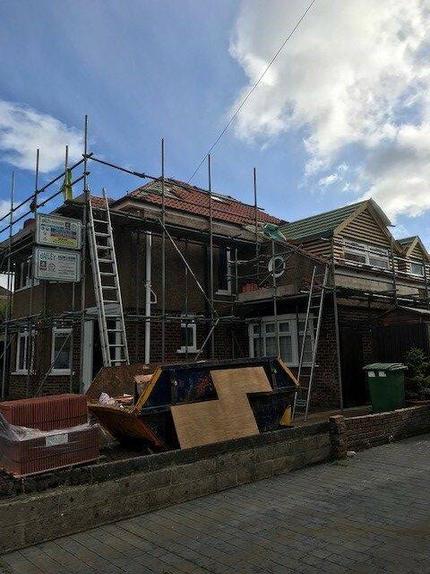 red brick house with scaffolding up
