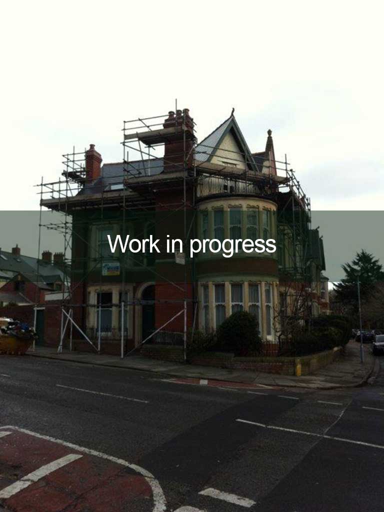 roofing work in progress on red brick house